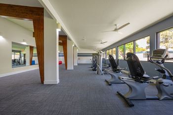 a room filled with lots of chairs and exercise equipment